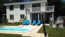 modern white house, with balcony, 3 lounge chairs, swimming pool, grass, flower beds