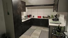 tiled floor, dark wood cabinets, countertop with modern sink, coffee machine, toaster, plants
