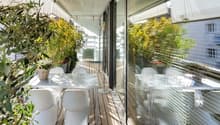 modern design white table and chairs, glass railings, plants, wooden floor