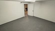 empty room, white walls, gray tiled floor, white door, fluorescent light