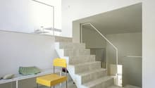 White marble stairs, yellow chair, stone countertop, marble flooring, modern design