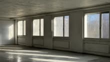 Empty room, large windows, white walls, wooden floor