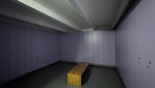 Storage room with tiled floor, wooden bench, lockers