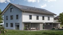 2-story house with solar panels on the roof, white exterior walls, large windows, patio with outdoor furniture, and a grassy yard with flowers.