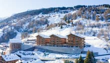 wooden exterior, multi-level residential building, large windows, snow covered surroundings, under construction area