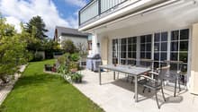 patio with table and chairs, plants, grass, balcony