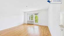 empty room, wooden floor, white walls, large window, balcony