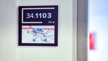 The image shows a framed display with the number 34.1103 and the text 'PC-6' below it. The display also includes an image of a small propeller plane on a snowy surface.
