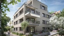 3 story building, balconies, plants, paved walkway, garden