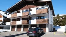 2 story house, white and brown, 3 garages, balcony, snow on the ground