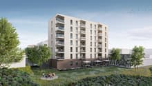 modern apartment building, several floors, multiple balconies, open courtyard, greenery, barbecue, and seating areas with umbrellas