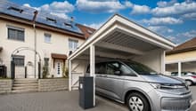 House with solar panels, carport, and a silver car parked under it
