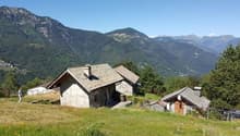 Mountain chalet with mountain view, two structures with stone walls, a fence