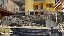yellow facade, stone wall, steps, balcony