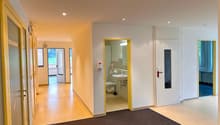 Empty bathroom, bathroom door, sink, toilet, tiled floors, mirror, yellow accents