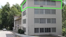 2 story building, large windows, driveway, green outline