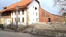 Modern 2 story house, wood exterior, red roof, large windows, balcony