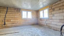 empty room, brick walls, concrete floor, two windows, unfinished