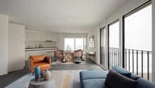 open floor plan, large windows, balcony, modern furnishings, neutral color scheme