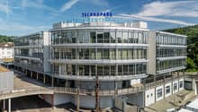 TECHNOPARK building, multiple floors, glass walls, curved design, green rooftop