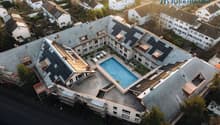 Residential building, multiple units, rooftop solar panels, central swimming pool, courtyard area