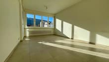empty room, large window, tiled floor, white walls, radiator
