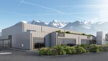 Modern two-story commercial building, grey exterior, glass windows, green roof, mountain view, multiple garage spaces, pedestrian area
