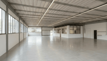 spacious room, white walls, concrete floor, large windows, metal beams, fluorescent lighting