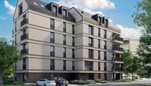 multi-storey building, numerous balconies, multiple parking spaces, surrounded by greenery