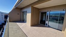 large balcony, glass doors, tiled floor, metal railing, view of the mountains