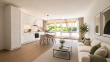 Spacieux séjour lumineux avec cuisine ouverte moderne et accès balcon / a modern living room with white furniture and a large window overlooking a kitchen and living area with a table and chairs