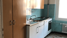 kitchen with wooden cabinets, white appliances, tiled floor, blue tiles on wall, window
