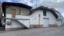 2 story building, white and brown walls, 2 garages, stairs