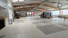 Warehouse: large open space, wooden beams, windows, forklift, storage boxes, white walls, cement floor