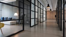 modern office space, glass walls, concrete floor, white walls, modern furniture, lamps