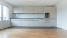 modern kitchen with white cabinets, wooden floor, large window, stainless steel oven, sink with faucet