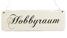 White sign with 'Hobbyraum' written in black cursive font