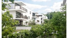white modern apartments, balconies, green surroundings