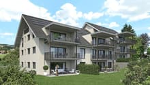A two-story house with balconies, solar panels on the roof, white outdoor furniture, and a grassy yard.