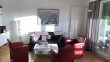 Large room with modern furniture, two sofas, coffee table, and a framed picture on the wall.