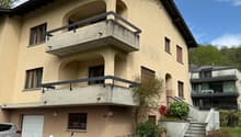 2 story house, beige exterior, garage, balcony, plants, steps, car parked