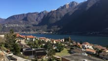 Mountain view, lake view, town view, multiple houses, trees, mountains