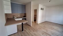 modern kitchen, equipped with stainless steel appliances, wooden countertops, white cabinets, hardwood floors, open to the living area