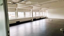 empty room, large windows, gray floors, white walls, long benches