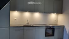 modern kitchen, wood floor, gray cabinets, modern sink, gas stove, under-cabinet lighting