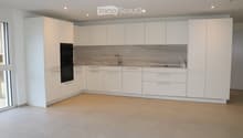 white kitchen, marble countertops, double oven, sink, faucet, glass windows, tiled floor