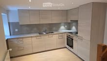 light wooden cabinetry, marble counter tops, stainless steel sink and faucet, integrated dishwasher, oven and microwave