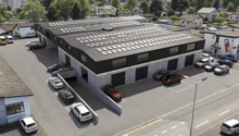 Commercial building with solar panels on the roof, multiple parking spaces, modern design, surrounded by trees and other buildings