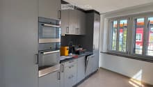 modern kitchen with gray cabinets, stainless steel appliances, and a dishwasher