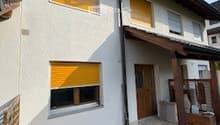 white house, yellow shutters, wooden door, wooden awning, paved entrance